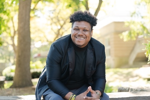 As the grandson of an English teacher, Adonis Richards has always had a passion for literature. He soon discovered that storytelling could be channeled through poetry. He wrote his first poem for a hip-hop showcase while a senior at SUNY Potsdam. Now 31, he continues to write poetry on a regular basis and is the author of three collections: “Confessions of a Hopeless Creative,” “Reflections of a Hopeless Creative,” and “The Quarantine Chronicles.” He also performs spoken-word poetry at public events. “I wri