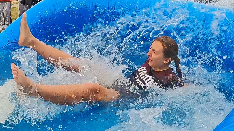 A student splashes in the pool as part of the Dip tradition